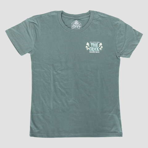 front view of ladies cut The Crick Tee with front text on shirt "THE LIVING WOOD THE CRICK BAHUMIA"