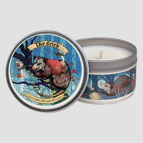 Candle in a tin with 'The Crick' design on the lid featuring opossum