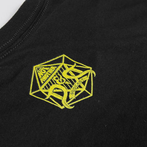 closeup of yellow NADDPOD logo on upper back of black tee