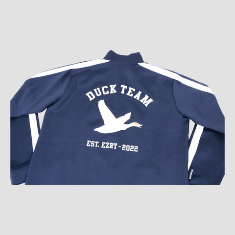 rear ANGLED view of navy and white track jacket with white duck on back with text "DUCK TEAM EST. EZRY - 2022"