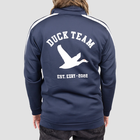 rear view of navy and white track jacket on male model with white duck on back with text "DUCK TEAM EST. EZRY - 2022"
