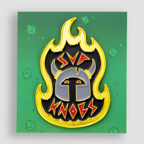 Pin with outline of flames with image of helmet with horns and red text "SUP KNOBS"