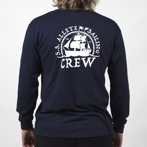 back view of male model in navy longsleeve shirt with white graphic of sailboat surrounded by text "S.S. ALLETE SAILING CREW"