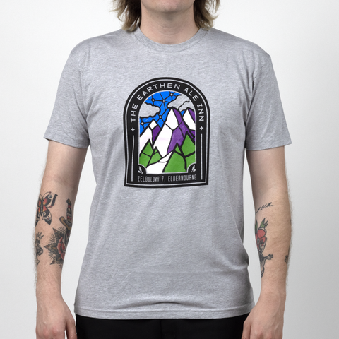 Male model in Earthen Ale shirt with graphic of stained glass mountains with text "THE EARTHEN ALE INN"