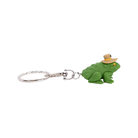 Green frog keychain with a hat on a white background