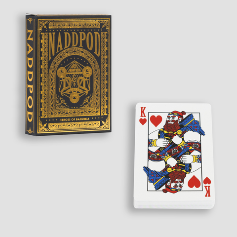 Playing card deck with King of hearts facing up, and Deck Box showing gold "NADDPOD HEROES OF BAHUMIA" text and gold NADDPOD logo