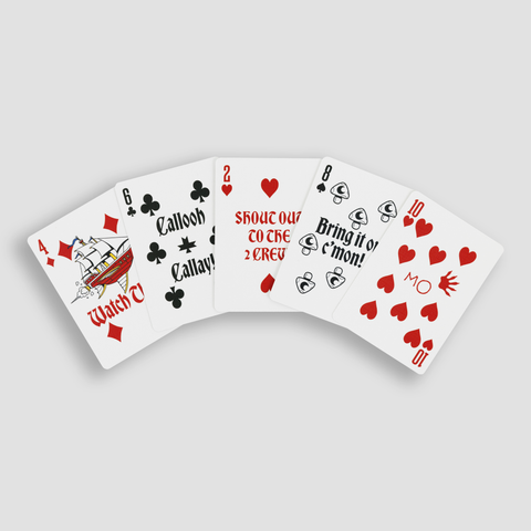 Playing cards spread out showing various NADDPOD themes 4 of diamonds with graphic of sailboat, 6 of clubs with text "Callooh Callay!", 2 of hearts with "Shout Out To The 2 CREW" text, 8 of spade with "Bring it on c'mon!" text, 10 of hearts with "MO" text