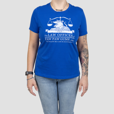Blue shirt on female model with text "The LAW OFFICES OF PAW PAW GUMP, ESQ. "The Scramble Man with the Scramble Plan."" with graphic of opossum in front of balance