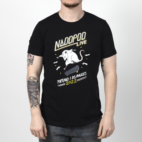 Male model in black shirt with graphic of a possum doing a kickflip with text "NADDPOD LIVE PORTLAND & LOS ANGELES 2022"